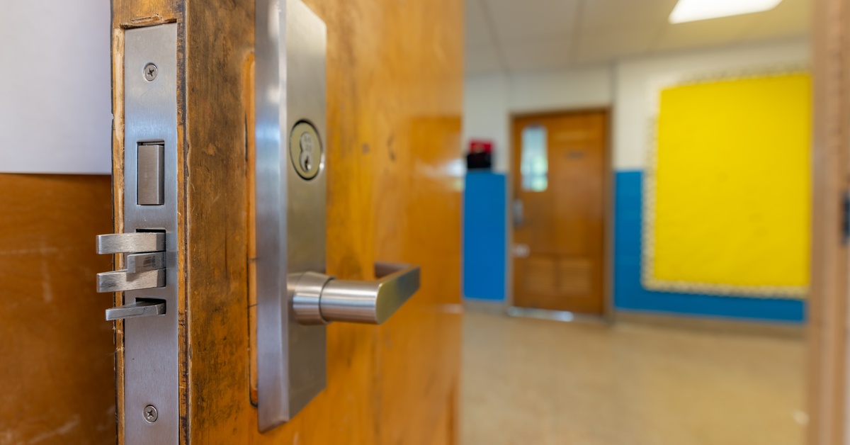 A door with the handle and lock mechanisms visible. The open door showcases a hallway with another door across from it.